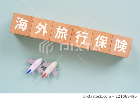 Blocks with the words "overseas travel insurance" and an airplane 121069480