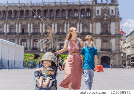 Mother, baby son and teenage son tourists in the central square of Mexico City, Zocalo. Family travel, cultural exploration, and historic architecture concept 121069571
