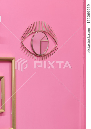 Stylish Eye Wall Art Featuring a Beautiful Design on a Soft Pink Background Wall Stylish Eye Wall Art Featuring a Beautiful Design on a Soft Pink Background Wall 121069939