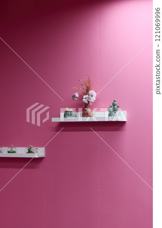 Charming and Elegant Shelves Beautifully Decorated on a Stylish Pink Wall Display Charming and Elegant Shelves Beautifully Decorated on a Stylish Pink Wall Display 121069996