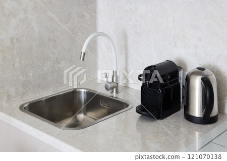A Contemporary Modern Kitchen Sink equipped with a Coffee Machine and a Kettle for brewing 121070138