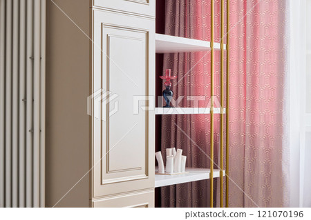 An Elegant Interior Featuring Stylish Shelves and Drapes in Soft, Inviting Colors 121070196