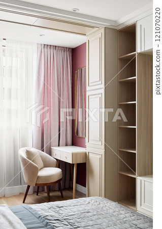 Stylish Modern Bedroom featuring Elegant Decor, Comfortable Furniture, and Cozy Workspace 121070220