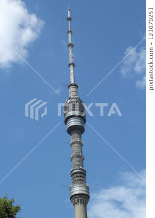 The Ostankino Tower in Moscow stands majestically under a clear and beautiful blue sky 121070251
