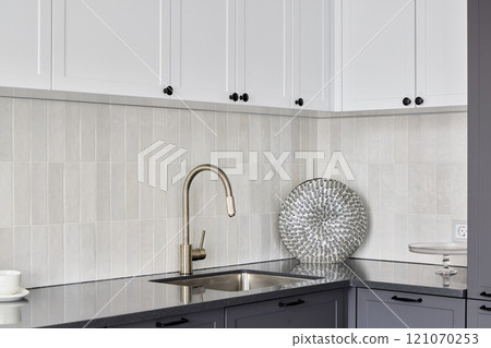 A Modern Kitchen Design Featuring Elegant Fixtures Accompanied by Stylish Accents and Touches 121070253