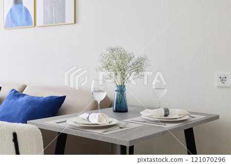 An Elegant Dining Table Setup Featuring Modern Decor and Stylish Elements for Ambiance 121070296