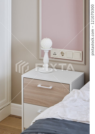 A Modern Nightstand Featuring a Stylish Lamp and Convenient Wall Outlet for Your Bedroom 121070300