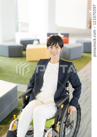 Working female wheelchair user 121070397