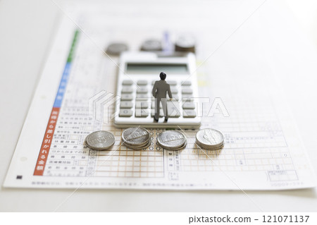 Tax return Money image Male miniature, calculator, coins and tax return Tax return Money image Male miniature, calculator, coins and tax return 121071137