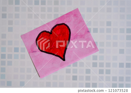 A red love heart drawn on a sticky note or post-it 121073528