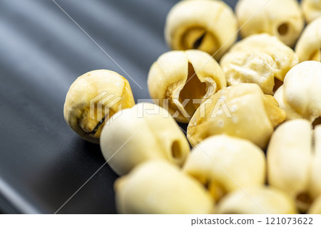 Closeup view of lotus seeds (Nelumbo nucifera) in the bowl Closeup view of lotus seeds (Nelumbo nucifera) in the bowl 121073622