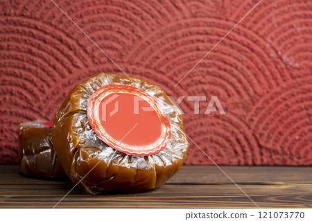 Chinese New Year rice cake or Nian Gao on the table. Also popular as Kue Keranjang or Dodol China Chinese New Year rice cake or Nian Gao on the table. Also popular as Kue Keranjang or Dodol China 121073770