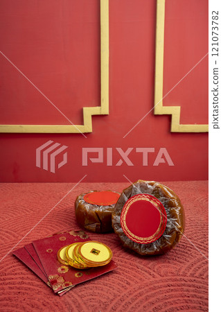 Chinese New Year rice cake or Nian Gao with angpao and Chinese golden coin on a red background Chinese New Year rice cake or Nian Gao with angpao and Chinese golden coin on a red background 121073782