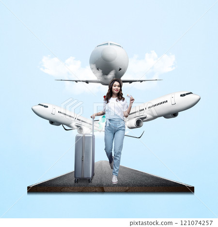 Portrait of a woman in a hat standing with a suitcase while holding a credit card with a flying commercial airplane in the sky background Portrait of a woman in a hat standing with a suitcase while holding a credit card with a flying commercial airplane in the sky background 121074257