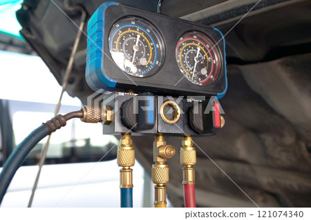 Checking car air conditioning system: refrigerant recharge, connecting pipes for freon refill Checking car air conditioning system: refrigerant recharge, connecting pipes for freon refill 121074340