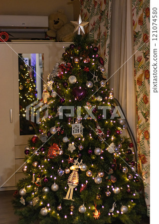 Close up Christmas tree with awesome toys in a cozy living room Close up Christmas tree with awesome toys in a cozy living room 121074580