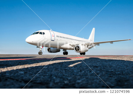 White passenger jet plane on the airport apron White passenger jet plane on the airport apron 121074596