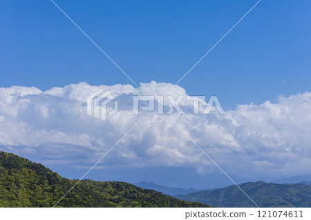 Many cumulonimbus clouds flowing over the mountain top 121074611