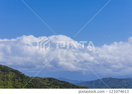 Many cumulonimbus clouds flowing over the mountain top 121074613