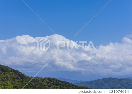 Many cumulonimbus clouds flowing over the mountain top 121074614