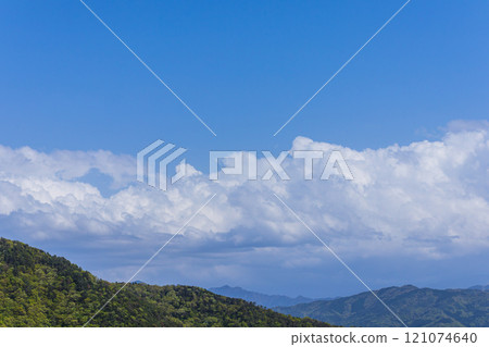 Many cumulonimbus clouds flowing over the mountain top 121074640