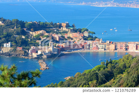 View from rock on sea, Bay of Silence, fishing cove of the town of Sestri-Levante, Italy. Tourism and recreation. Ecologically clean nature. Traditional old buildings. Historical center. 121076289