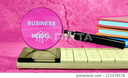 Business concept. BUSINESS MODEL text written on the glass of the magnifying glass 121076576
