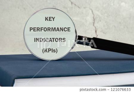 Data analytics automated with AI technology. KEY PERFORMANCE INDICATORS (KPIs on the glass of a magnifying glass on a gray background Data analytics automated with AI technology. KEY PERFORMANCE INDICATORS (KPIs on the glass of a magnifying glass on a gray background 121076633