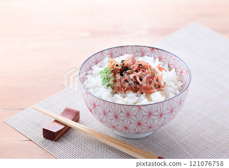 Dried small sardines with plums served on steaming rice Dried small sardines with plums served on steaming rice 121076758