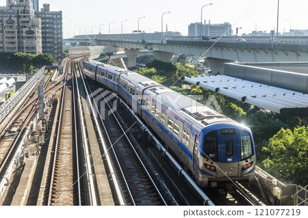 View of a Taoyuan International Airport line train running on the elevated track of the Taoyuan Mass Rapid Transit System. View of a Taoyuan International Airport line train running on the elevated track of the Taoyuan Mass Rapid Transit System. 121077219
