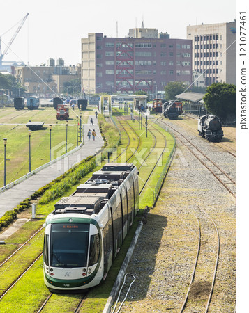 The circular light rail train drives past Hamasen Railway Cultural Park in Kaohsiung, Taiwan. 121077461