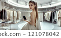 Beautiful young model is shopping in a large department store. 121078042