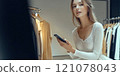Beautiful young model is shopping in a large department store. 121078043