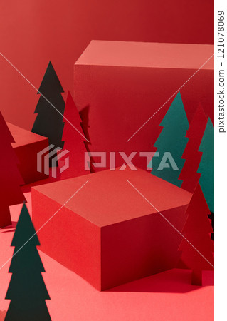 A Christmas concept of a template photo features some red rectangular podiums, with an empty space for displaying products, next to green and red paper-cutting Noel trees, in the red background. A Christmas concept of a template photo features some red rectangular podiums, with an empty space for displaying products, next to green and red paper-cutting Noel trees, in the red background. 121078069