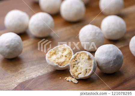 Snowball cookies lined up on a wooden background Snowball cookies lined up on a wooden background 121078295