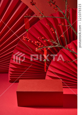 The front of the red rectangular platform has empty space for show products, a winterberry branch hanging from a lucky string, and red paper fans. A template image with an Asian New Year theme. The front of the red rectangular platform has empty space for show products, a winterberry branch hanging from a lucky string, and red paper fans. A template image with an Asian New Year theme. 121078315