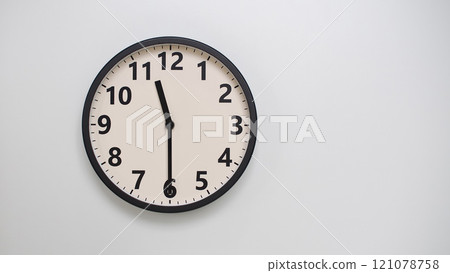 Classic Black-Edged Clock on White Background at 23.30/11.30 - Perfect for Time Management and Text Space 121078758