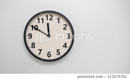 Classic Black-Edged Clock on White Background at 11.50/23.50 - Perfect for Time Management and Text Space Classic Black-Edged Clock on White Background at 11.50/23.50 - Perfect for Time Management and Text Space 121078762