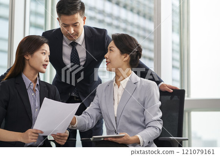 asian corporate executives meeting in office discussing business plans 121079161