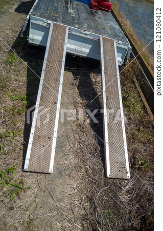 A homemade ramp for a light truck to load and unload farm equipment 121080412
