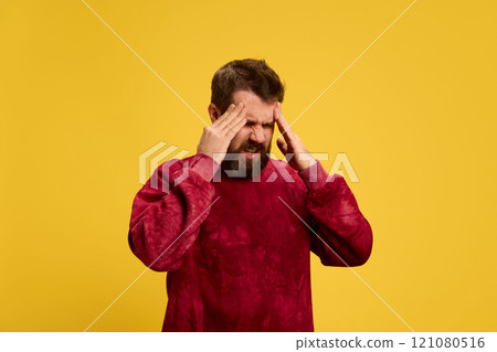 Young man, sick guy holding hands on head as he feel pain against bright yellow background. Viruses and symptoms. Young man, sick guy holding hands on head as he feel pain against bright yellow background. Viruses and symptoms. 121080516