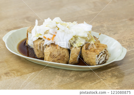 Close-up of delicious stinky tofu on the table. It is a common street snack in night markets or roadside stalls in Taiwan and is very popular among tourists. 121080875