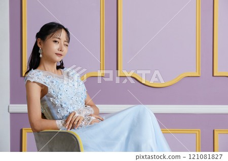Portrait of a young woman in a dress photographed against an antique background Portrait of a young woman in a dress photographed against an antique background 121081827