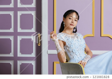 Portrait of a young woman in a dress photographed against an antique background Portrait of a young woman in a dress photographed against an antique background 121081828