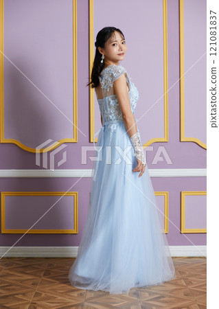Portrait of a young woman in a dress photographed against an antique background Portrait of a young woman in a dress photographed against an antique background 121081837