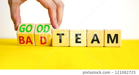 Good or bad team symbol. Concept words Good team Bad team on wooden cubes. Beautiful yellow table white background. Businessman hand. Business and good or bad team concept. Copy space. 121082725