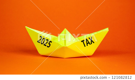 Planning 2025 tax new year symbol. Concept words 2025 Tax on beautiful yellow paper boat. Beautiful orange paper background. Business 2025 tax new year concept. Copy space. 121082812