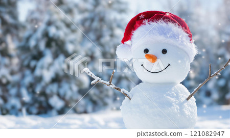 Winter holidays christmas background banner - close up of cute funny smiling snowman wearing woolen hat and scarf 121082947