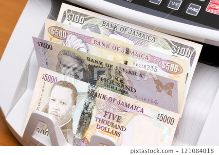 Jamaican dollar in the counting machine 121084018