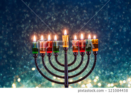 Hanukkah Menorah with burning candles on dark background with bokeh lights. 121084438